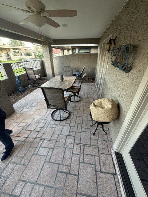 Dated gray brick covered patio before travertine paver remodel in Phoenix, Arizona