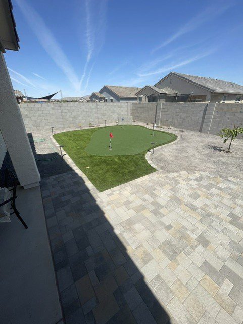 Finished paver patio with artificial turf putting green in a Phoenix, Arizona backyard