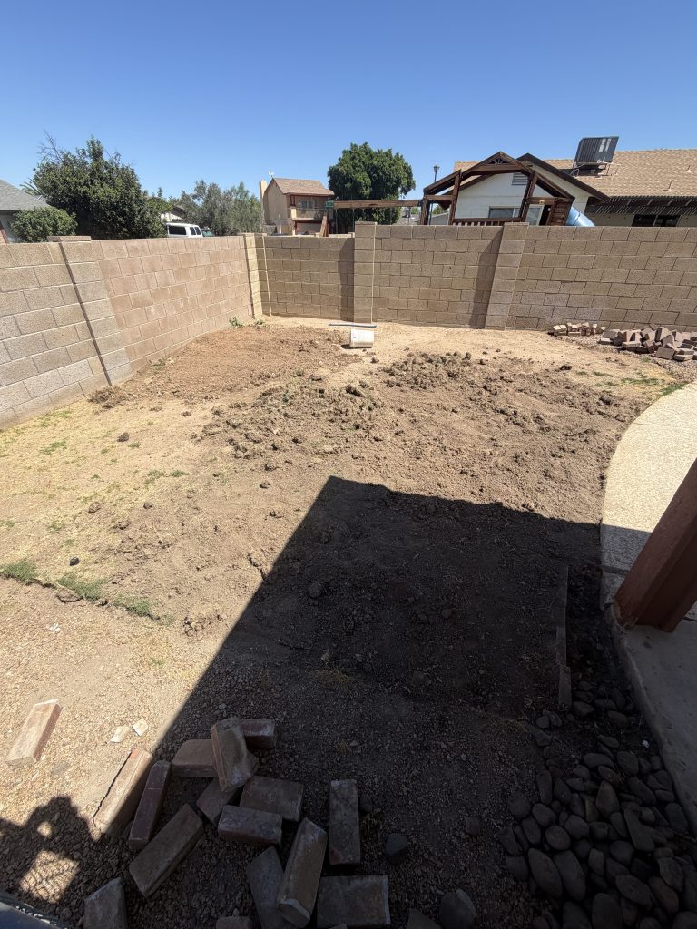 Bare dirt backyard before artificial turf installation in Phoenix, Arizona