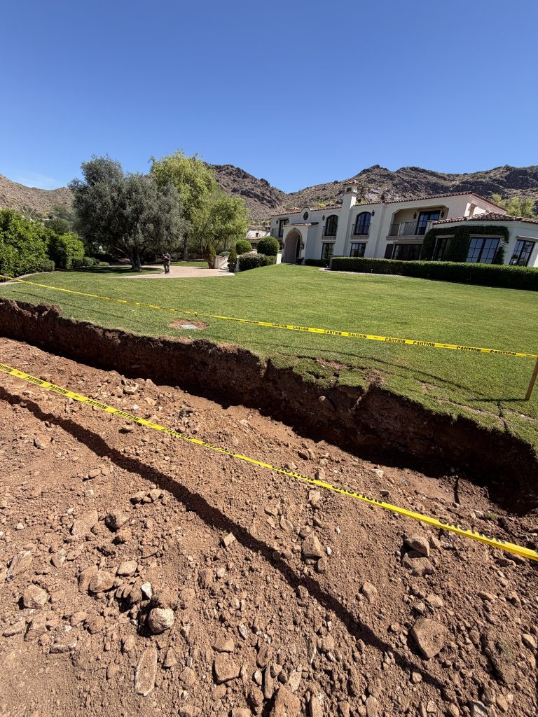 Sloped Phoenix backyard before retaining wall installation
